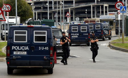 Spanish national police vehicles enter the port where hundreds of Spanish national police and civil guard reinforcements are housed in two ferries a day before the banned October 1 independence referendum, in Barcelona, Spain, September 30, 2017. REUTERS/Eloy Alonso