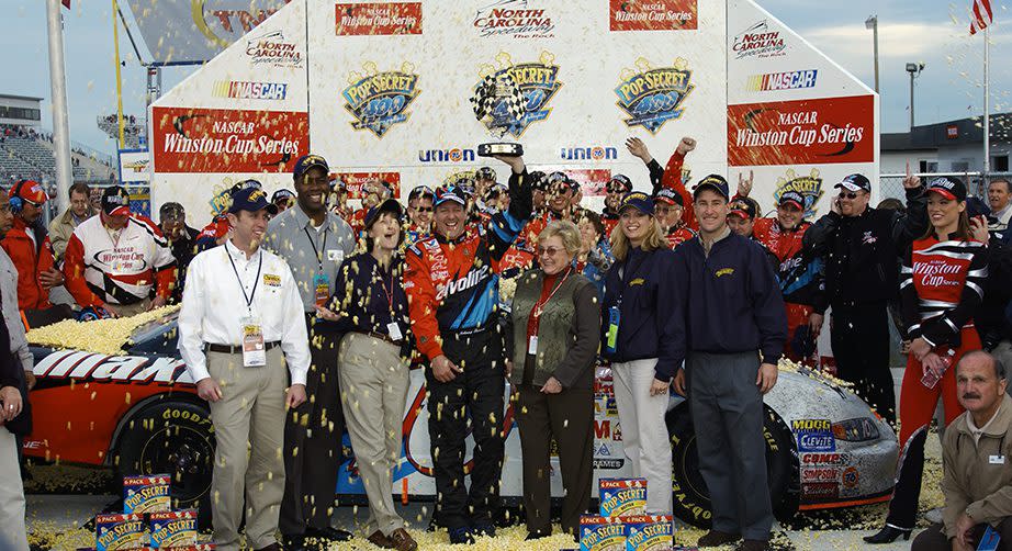 ROCKINGHAM, NC - NOVEMBER 3: Johnny Benson, driver fo the #10 Valvoline PontiacGrand Prix, celebrates winning the NASCAR Winston Cup Pop Secret Microwave Popcorn 400 on November 3, 2002 at North Carolina Speedway in Rockingham, North Carolina. (Photo By Rusty Jarrett/Getty Images) | Getty Images