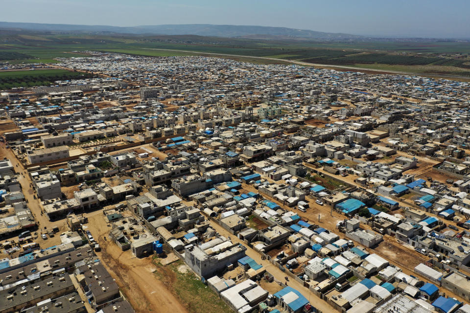 This April 19, 2020 photo shows a large refugee camp on the Syrian side of the border with Turkey, near the town of Atma, in Idlib province, Syria. The rapid spread of the coronavirus has raised fears about the world’s refugees and internally displaced people, many of whom live in poor or war-ravaged countries that are ill-equipped to test for the virus or contain a possible outbreak. (AP Photo/Ghaith Alsayed)