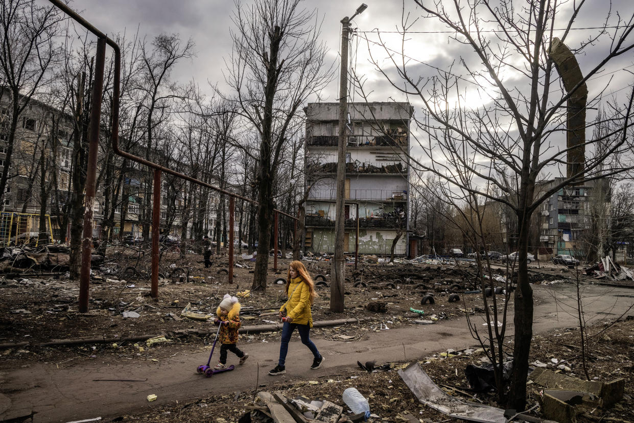 A mother and daughter walk through their destroyed neighborhood in Myrnohrad, a town in the Donetsk region of southeastern Ukraine, March 10, 2024. (David Guttenfelder/The New York Times)