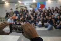 Reporters of Apple Daily take a photo at the headquarters in Hong Kong, Thursday, June 24, 2021. Hong Kong's pro-democracy Apple Daily newspaper will stop publishing Thursday, following last week's arrest of five editors and executives and the freezing of $2.3 million in assets under the city's year-old national security law. (AP Photo/Kin Cheung)