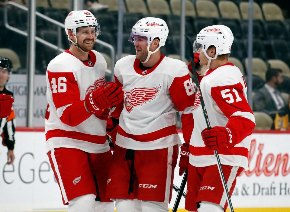 Detroit Red Wings defensemen Jeff Petry (46) and Eemil Viro (51) congratulate center Daniel Sprong (88) on his goal against the Pittsburgh Penguins during the second period at PPG Paints Arena in Pittsburgh, on Wednesday, Oct. 4, 2023.