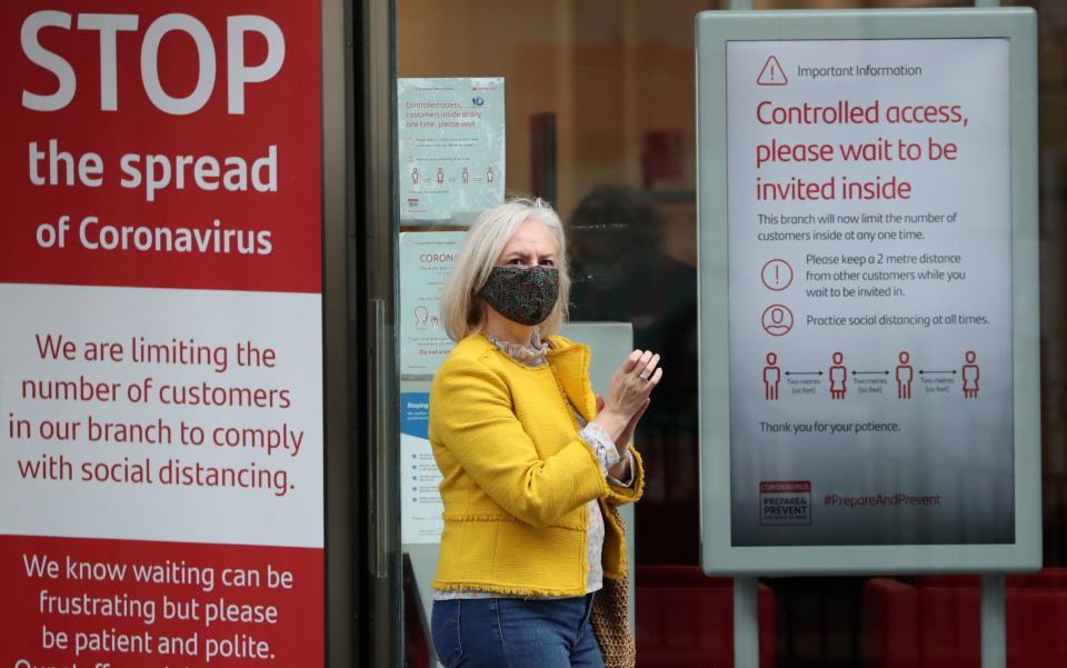 Woman and coronavirus signs - Andrew Milligan/PA