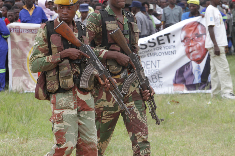 Armed soldiers patrol during Zimbabwe's President Robert Mugabe's celebrations to mark his 90th birthday in Marondera about 100 kilometres east of Harare, Sunday, Feb. 23, 2014. Mugabe who is Africas oldest leader has been in power in the Southern African nation since 1980. (AP (AP Photo/Tsvangirayi Mukwazhi)