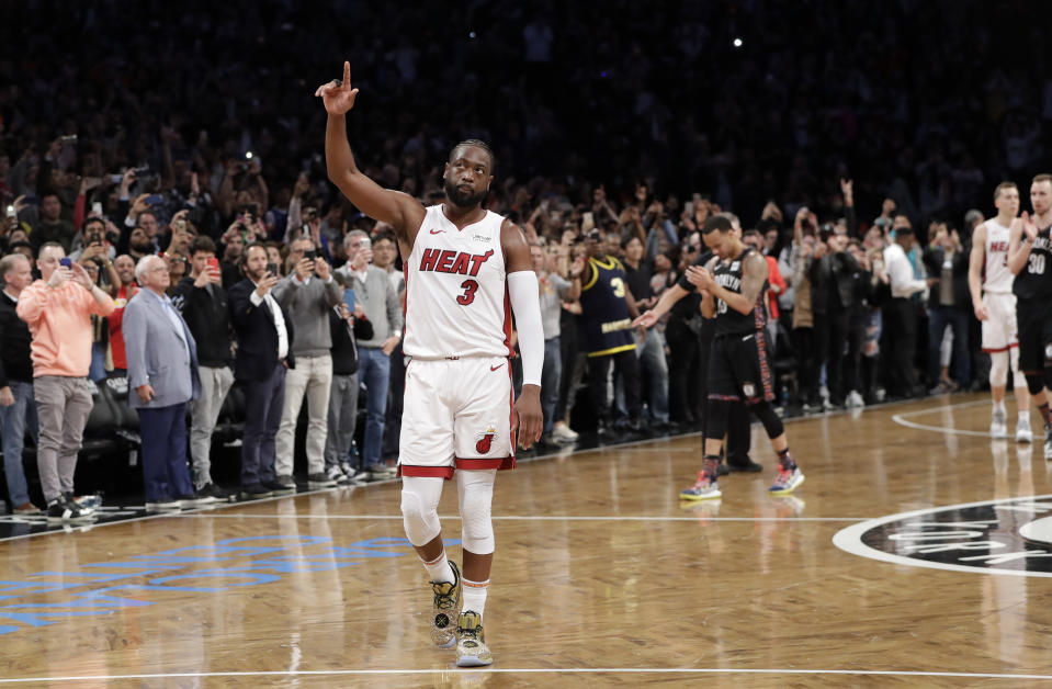 Miami Heat guard Dwyane Wade (3) acknowledges the crowd's cheers after playing in the final NBA basketball game of his career, against the Brooklyn Nets on Wednesday, April 10, 2019, in New York. (AP Photo/Kathy Willens)