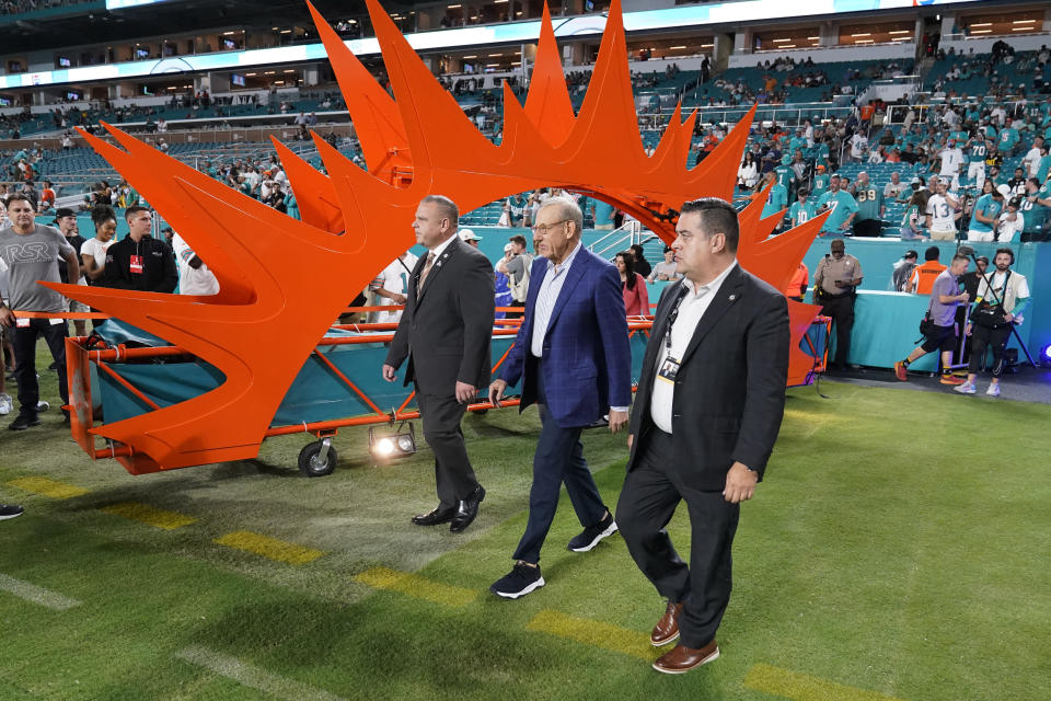 Miami Dolphins owner Stephen Ross, center, enters the field before an NFL football game against the Pittsburgh Steelers, Sunday, Oct. 23, 2022, in Miami Gardens, Fla. (AP Photo/Wilfredo Lee )