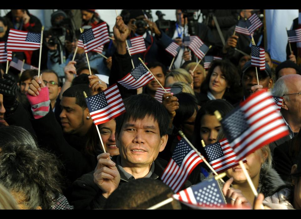 New citizens wave US flags before being sworn in during a Naturalization Ceremony conducted to swear in 125 new citizenship candidates at a ceremony on Liberty Island on October 28, 2011 to commemorate the 125th anniversary of the dedication of the Statue of Liberty.   AFP PHOTO/TIMOTHY A. CLARY (Photo credit should read TIMOTHY A. CLARY/AFP/Getty Images)