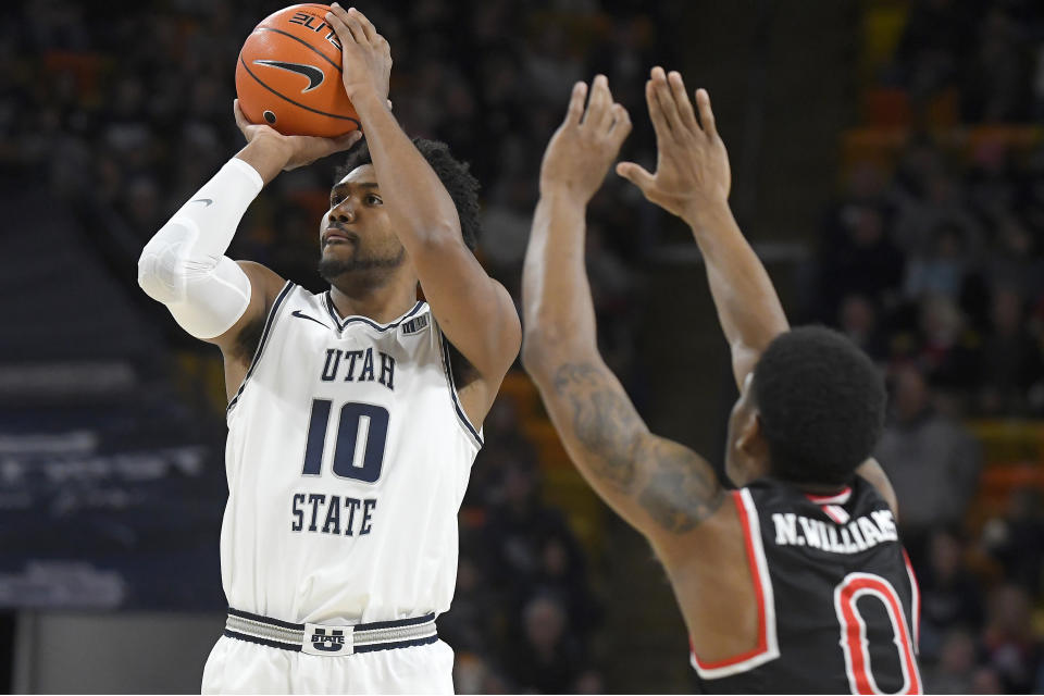 Utah State forward Alphonso Anderson (10) shoots as Fresno State guard New Williams (0) defends during the first half of an NCAA college basketball game Saturday, Dec. 7, 2019, in Logan, Utah. (AP Photo/Eli Lucero)