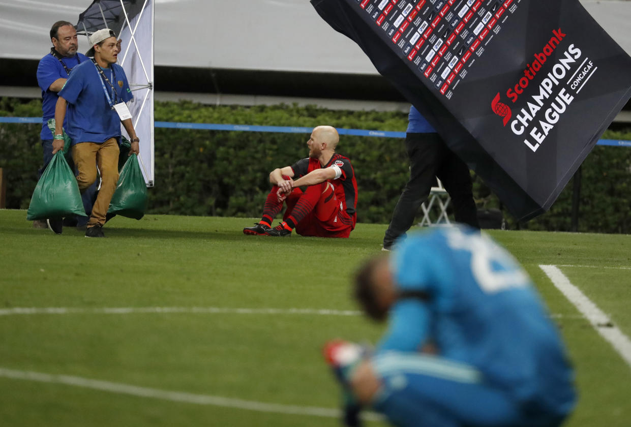 Toronto FC’s Michael Bradley and Alex Bono, right, sit dejectedly on the pitch after losing to Chivas in a penalty shootout in the CONCACAF Champions League final. (AP)