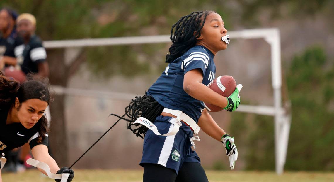 Knightdale High School’s Destiny Artiga (10) tries to stop Heritage High School’s Rizyha Rogers during a flag football scrimmage at Heritage High School in Wake Forest, N.C., Wednesday, Jan. 24, 2024.