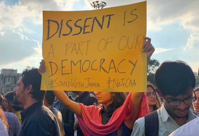 A demonstrator displays a placard during a protest to show solidarity with the students of New Delhi's Jamia Millia Islamia university, in Bengaluru