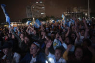 People watch the inauguration ceremony of incoming Guatemalan President Bernardo Arevalo on a screen outside the National Palace in Guatemala City, early Monday, Jan. 15, 2024. (AP Photo/ Santiago Billy)