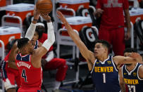 Washington Wizards guard Russell Westbrook (4) shoots against Denver Nuggets forward Michael Porter Jr. (1) during the first quarter of an NBA basketball game Thursday, Feb. 25, 2021, in Denver. (AP Photo/Jack Dempsey)