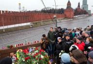 Russian mourners gather at the spot where opposition leader Boris Nemtsov was shot dead near St Basil's Cathedral in Moscow, on February 28, 2015