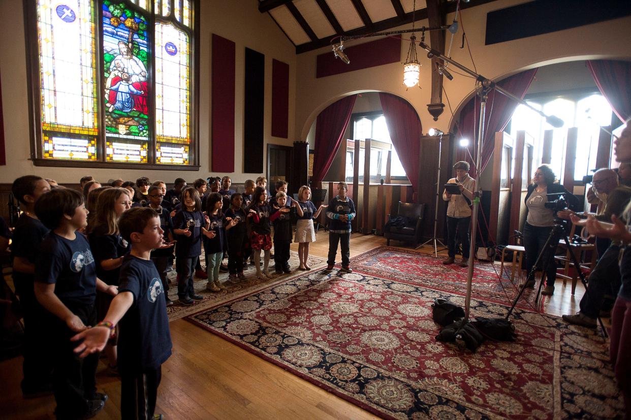 Second-grade students from Claxton Elementary sing a song at Echo Mountain Recording Studios. The recording studio will relocate from its downtown Asheville location to Marshall.