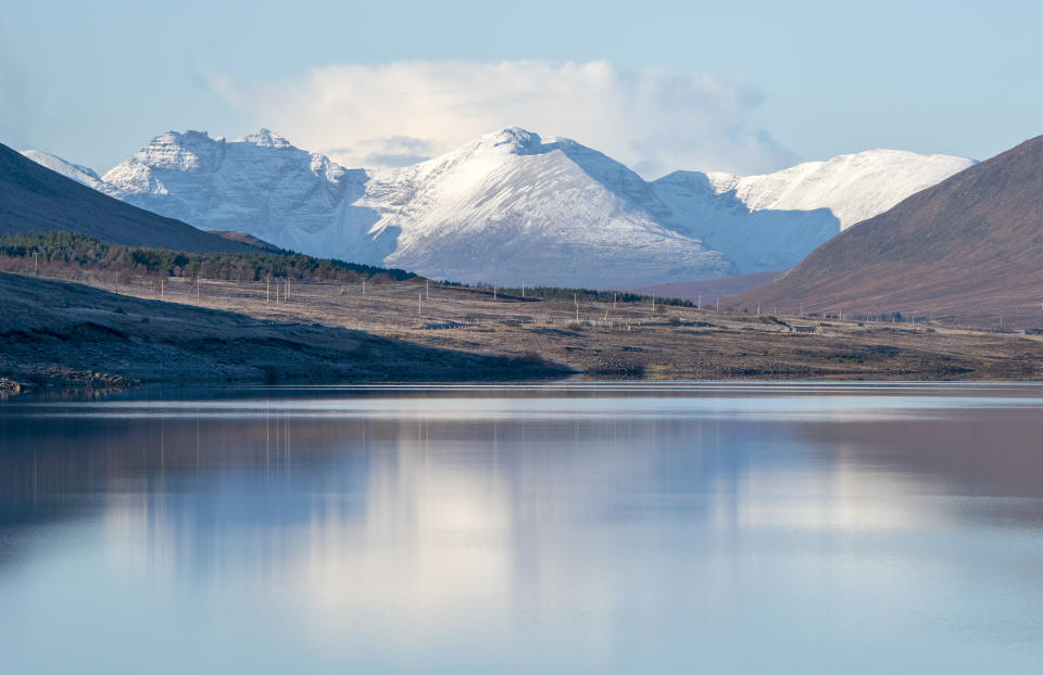 RETRANMITTING AMENDING LOCATION The snow-covered peak of Beinn Eighe and the mountains of Torridon are reflected in Loch Glascarnoch near Ullapool, Wester Ross. Picture date: Sunday December 3, 2023. (Photo by Jane Barlow/PA Images via Getty Images)