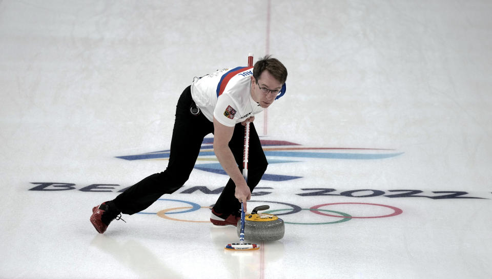 Czech Republic's Tomas Paul sweeps the ice during their mixed doubles curling match against Norway, at the 2022 Winter Olympics, Wednesday, Feb. 2, 2022, in Beijing. (AP Photo/Nariman El-Mofty)
