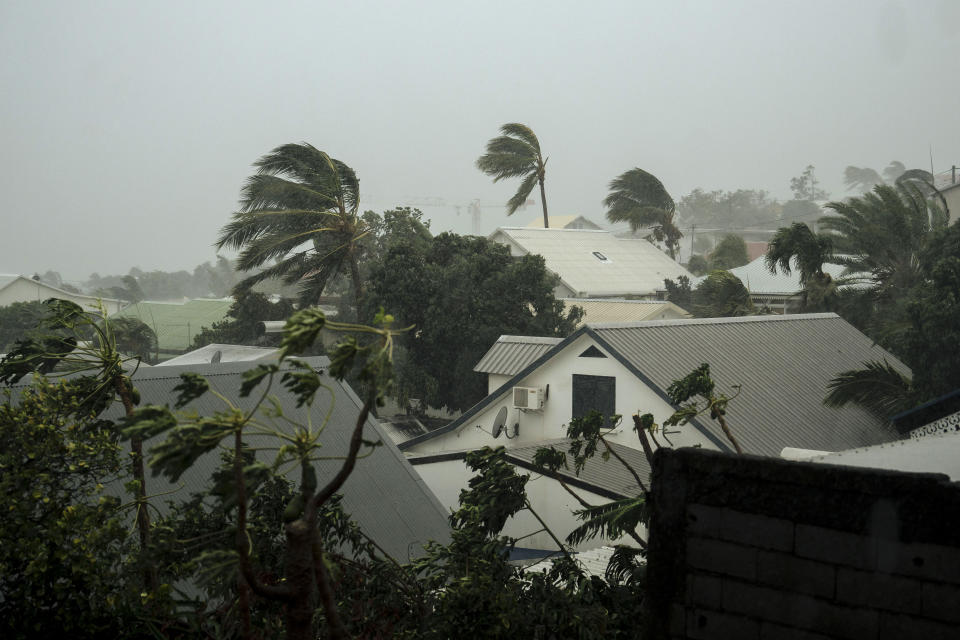 Strong winds blow in the town of La Plaine Saint-Paul on the French Indian Ocean island of Reunion, Monday, Jan. 15, 2024. Authorities urged residents on the French Indian Ocean island of Reunion to shelter indoors Sunday as a powerful storm bore down packing hurricane-force winds and Meteo France forecaster warned of winds that could top 250 kph (155 mph) Monday. In the French Indian Ocean island of Reunion, local authorities said Monday that the highest alert level has been lifted but residents were still urged to remain sheltered indoors. (AP Photo/Lewis Joly)