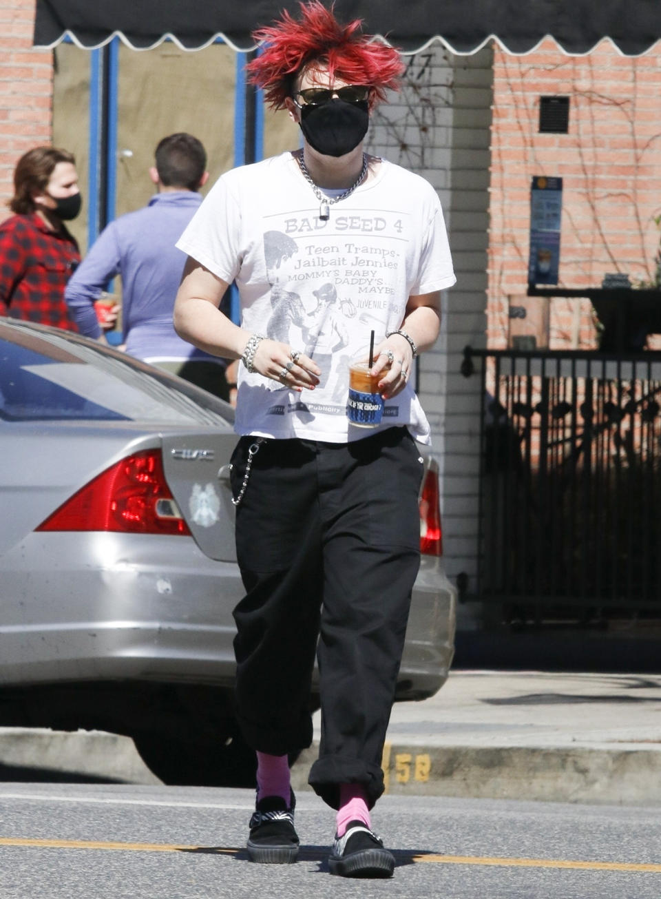 <p>Yungblud sports red hair, a tee and black trousers as he grabs coffee to go on Friday in West Hollywood.</p>