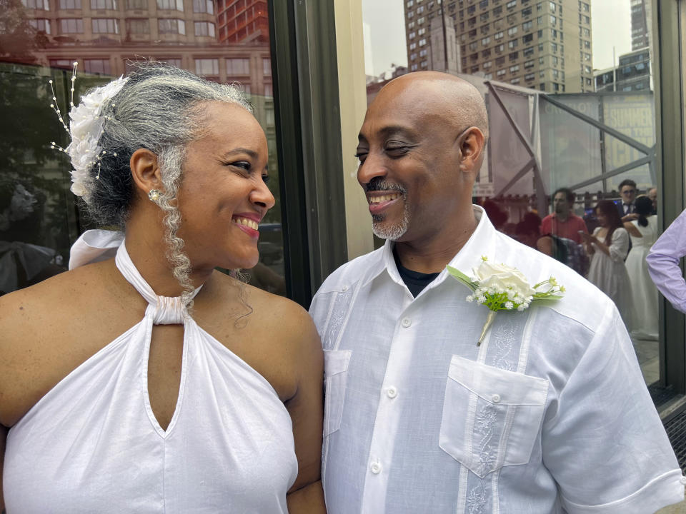 Hazel Seivwright-Carney and her husband, Rohan Carney, smile at one another, at New York's Lincoln Center, Saturday, July 8, 2023. The couple came to renew their vows at a mass wedding Saturday, after eloping 28 years earlier. (AP Photo/Bobby Caina Calvan)