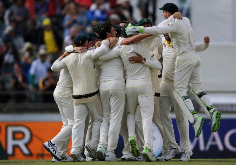 Australian players celebrate taking the Ashes series after bowling England out cheaply despite rain delays and a pitch controversy on the final day of the third Test