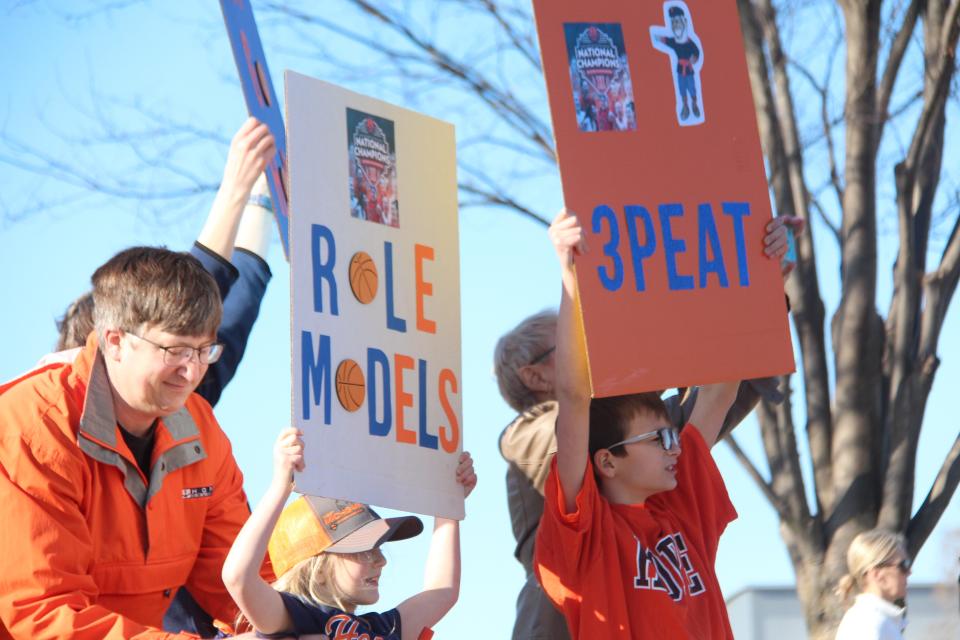 Two young Hope fans welcome the Hope women's basketball team back to Holland after winning the national championship