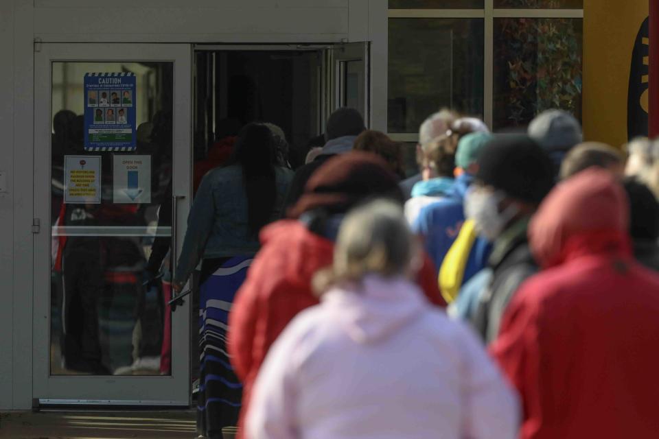 A member of the public waits in a long line in the cold to cast their vote on election day Tuesday, November 3, 2020, at Thurgood Marshall elementary school in Newark, DE.