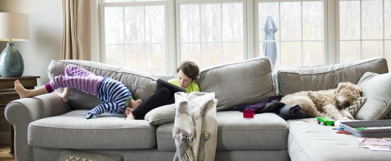 <span class="caption">Logging into school on the couch can make homelife more topsy-turvy.</span> <span class="attribution"><a class="link " href="https://www.gettyimages.com/detail/photo/siblings-on-sofa-at-home-royalty-free-image/961127740" rel="nofollow noopener" target="_blank" data-ylk="slk:Cavan Images/Getty Images;elm:context_link;itc:0;sec:content-canvas">Cavan Images/Getty Images</a></span>