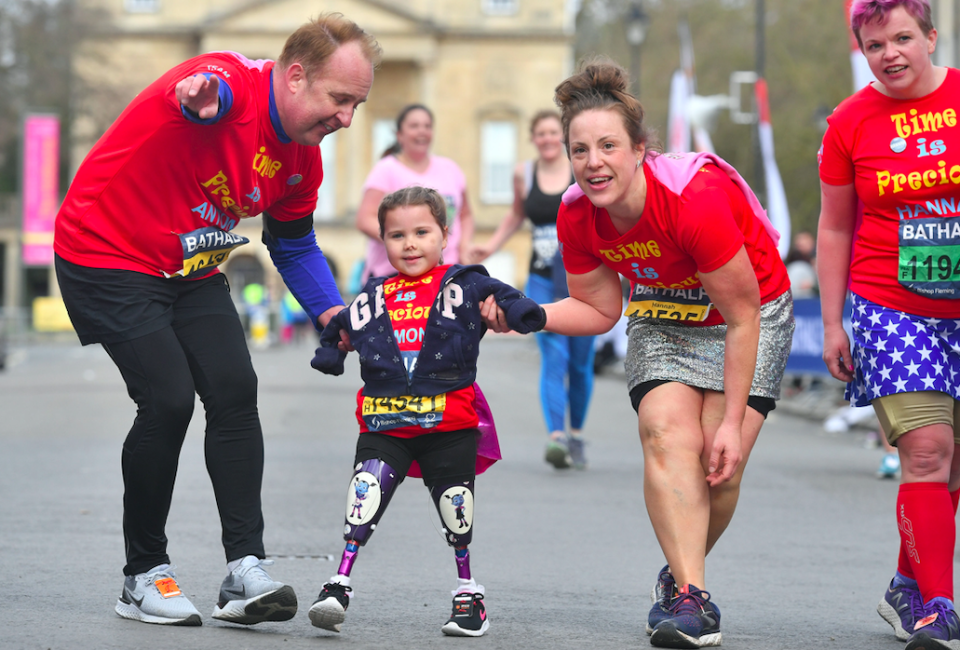 <em>The little girl had tackled the 13.1-mile course with a seven-person support team (PA)</em>