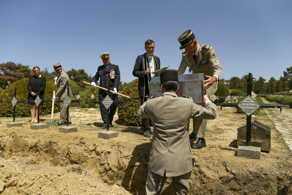 French army officers place the remains of 17 missing French soldiers who fought in the World War I Battle of Gallipoli, in Canakkale, Turkey, Sunday, April 24, 2022. The remains were on Sunday handed over to French military officials and put to rest alongside other fallen comrades, more than a hundred years after their deaths. The remains were found during restoration work on a castle and surrounding areas on Turkey's northwestern Canakkale peninsula, where Allied forces fought against Ottoman Turks in the ill-fated Gallipoli campaign that started with landings on the peninsula on April 25, 1915. (AP Photo/Emrah Gurel)