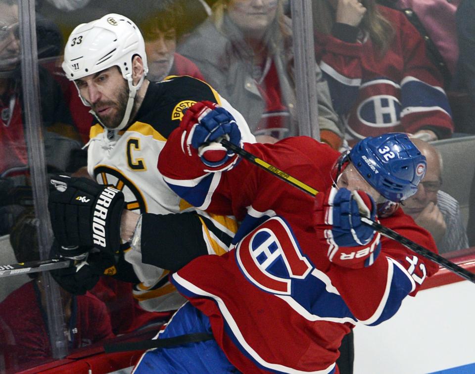 Boston Bruins defenseman Zdeno Chara (33) is checked by Montreal Canadiens left wing Travis Moen (32) during the third period in Game 4 in the second round of the NHL Stanley Cup playoffs Thursday, May 8, 2014, in Montreal. (AP Photo/The Canadian Press, Ryan Remiorz)