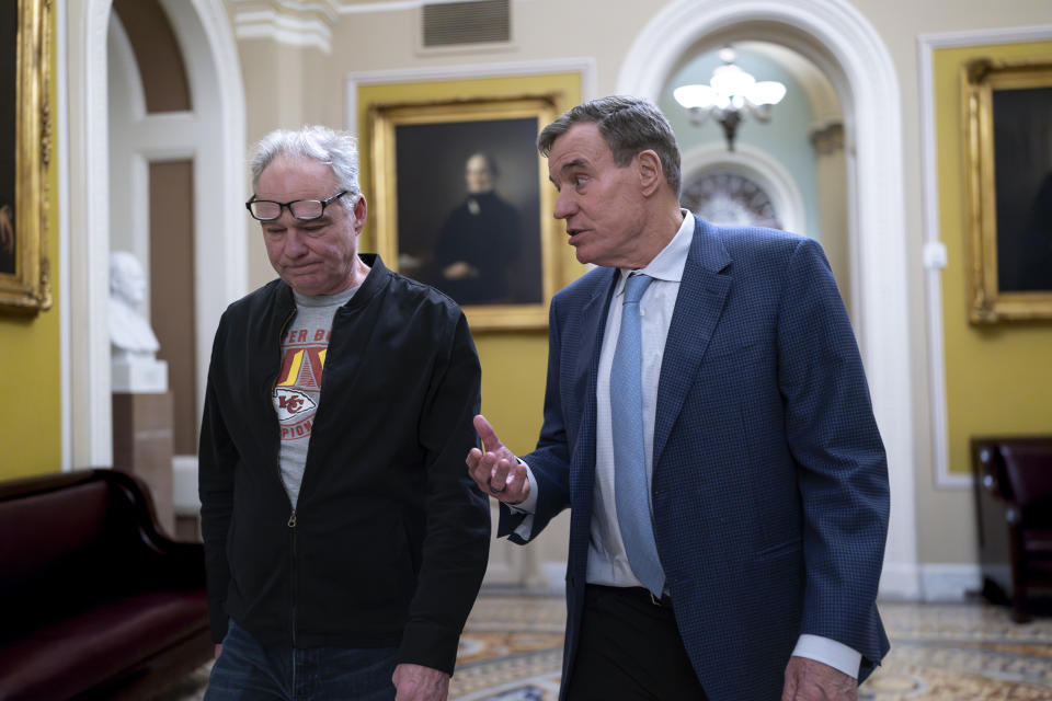 Sen. Tim Kaine, D-Va., left, and Sen. Mark Warner, D-Va., arrive as the Senate holds a procedural vote on a package of wartime funding for Ukraine, Israel and other U.S. allies, at the Capitol in Washington, Friday, Feb. 9, 2024. (AP Photo/J. Scott Applewhite)