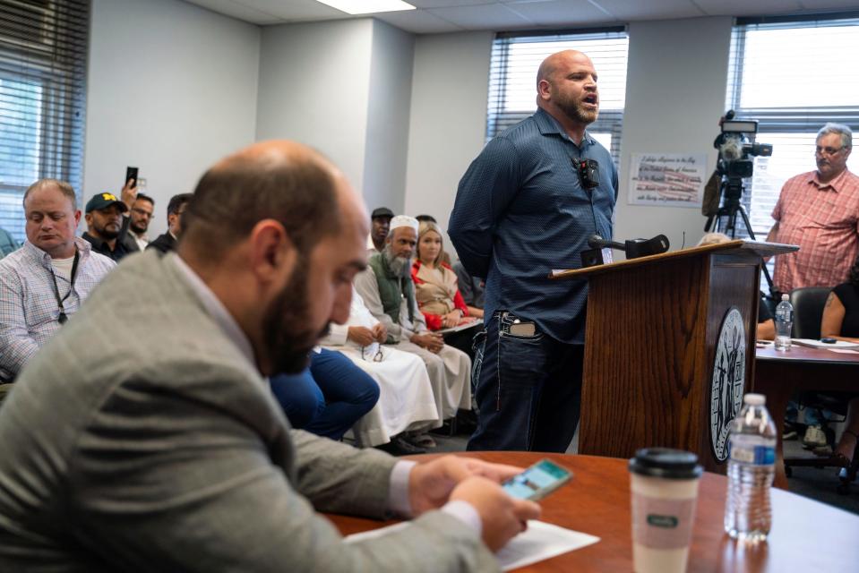 Hassan Aoun, of Dearborn, speaks during public comment at a city council meeting before a vote about banning the LGBTQ Pride flag on government buildings and city property, including other flags representing racial and political issues, at Hamtramck City Hall on Tuesday, June 13, 2023.