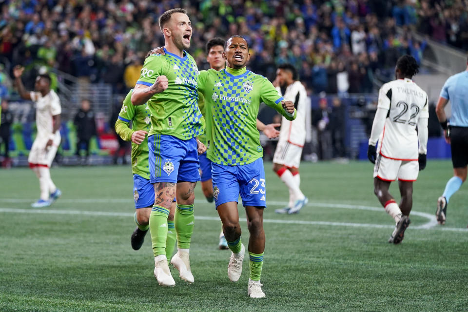 Seattle Sounders midfielder Albert Rusnák, left, celebrates after scoring on a penalty kick against FC Dallas with midfielder Léo Chú (23) during the first half of an MLS playoff soccer match Monday, Oct. 30, 2023, in Seattle. (AP Photo/Lindsey Wasson)