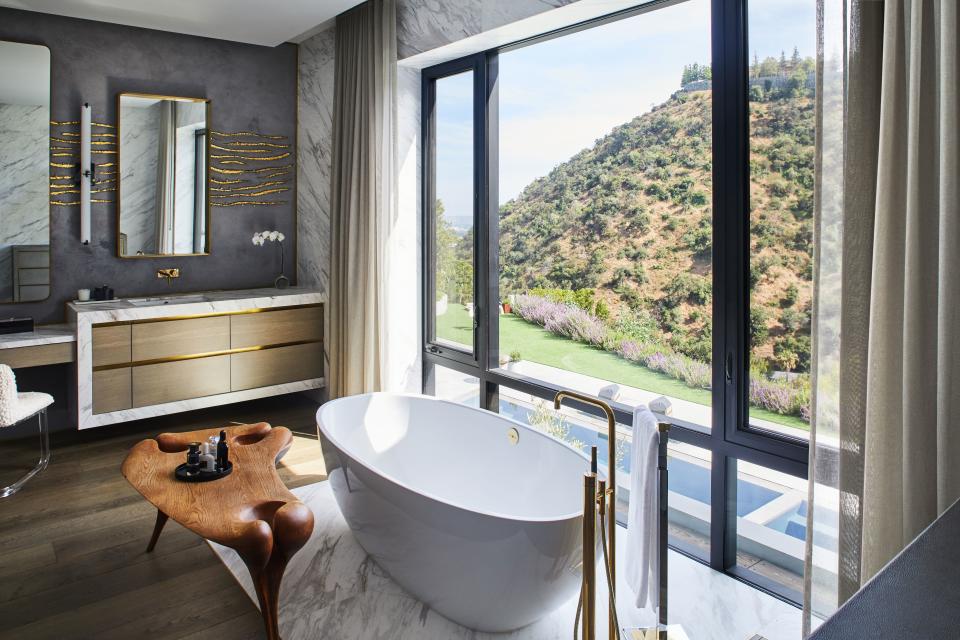 The gold stenciling in the master bathroom is the work of Soare herself. “It was an ‘in the moment’ decision," she says of the impulse addition. "I love to take baths and relax and look at the view and be zen.”