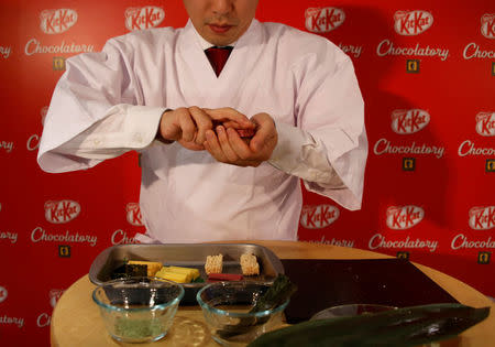 Nestle Japan's marketing department, confectionery business group manager Ryoji Maki poses with the company's sushi-shaped KitKats, for the upcoming Valentine's Day celebration, at its Ginza store in Tokyo, Japan, February 2, 2017. REUTERS/Toru Hanai