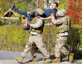 <p>Ben Rappaport gets carried away by Marines while filming <em>Modern Love</em> on Tuesday in Schenectady, New York.</p>