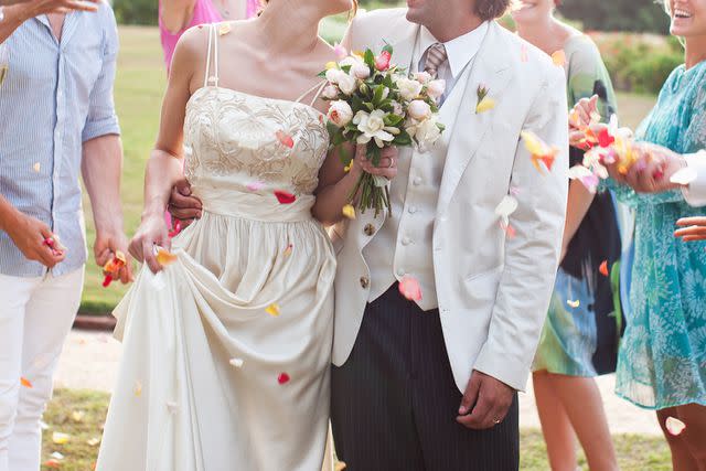 <p>Tom Merton/Getty</p> Stock photo of a bride and groom at their wedding