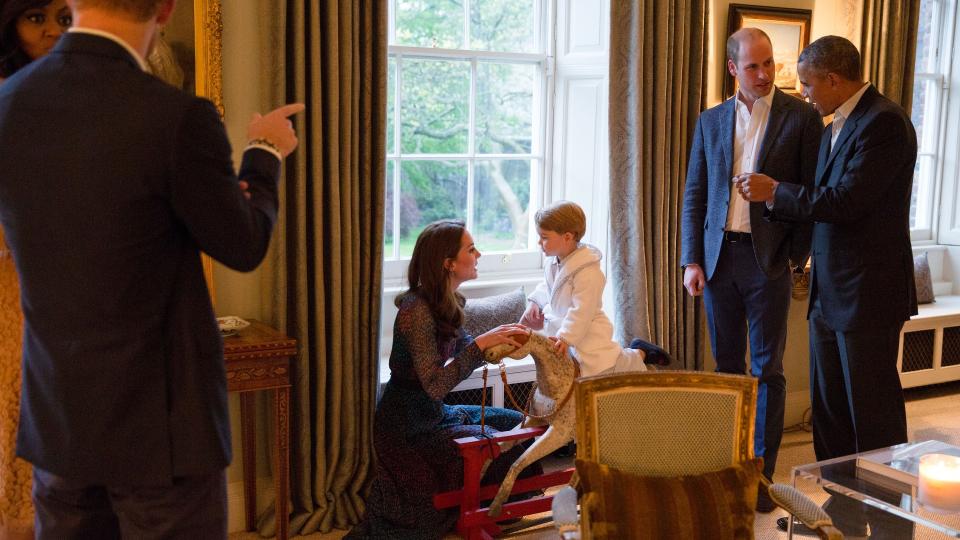 Prince George (in his robe) and his parents get a special visitor