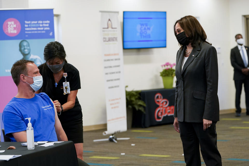 Vice President Kamala Harris talks to George Mitchell as he receives a COVID-19 vaccine at a COVID-19 pop-up center at Ebenezer Baptist Church, Friday, June 18, 2021, in Atlanta. (AP Photo/Jacquelyn Martin)