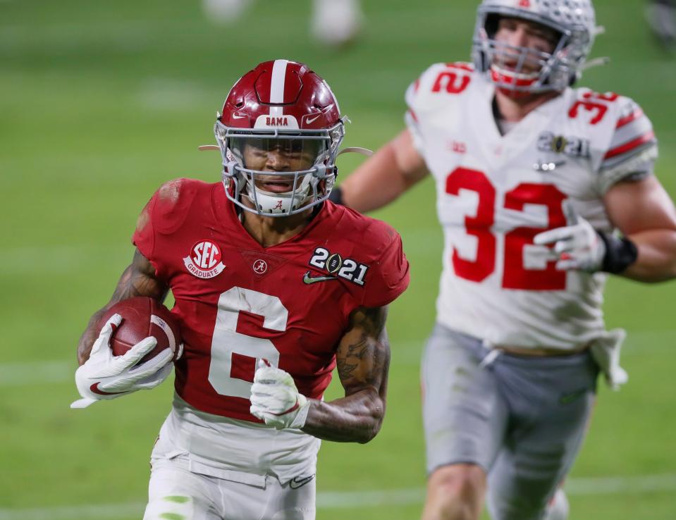 Alabama receiver DeVonta Smith catches a 42-yard touchdown behind Ohio State linebacker Tuf Borland during the second quarter of the College Football Playoff National Championship Game, Jan. 11, 2021 in Miami Gardens, Fla.