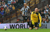 Newcastle United's Yoan Gouffran celebrates as Aston Villa's Brad Guzan kneels dejected at Newcastle United's second goal during the Barclays Premier League match at Villa Park, Birmingham.