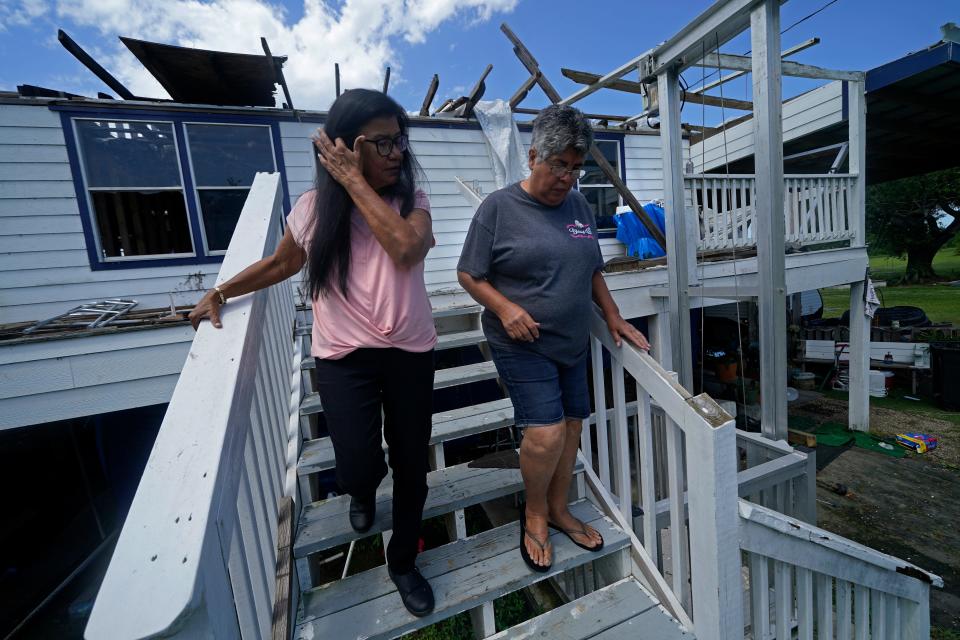 Louise Billiot, left, a member of the United Houma Nation, walks the home of her friend and tribal member Irene Verdin, on May 24, 2022, in Pointe-aux-Chenes. Irene's house was severely damaged by Hurricane Ida, which made landfall near Cocodrie on Aug. 29, 2021.