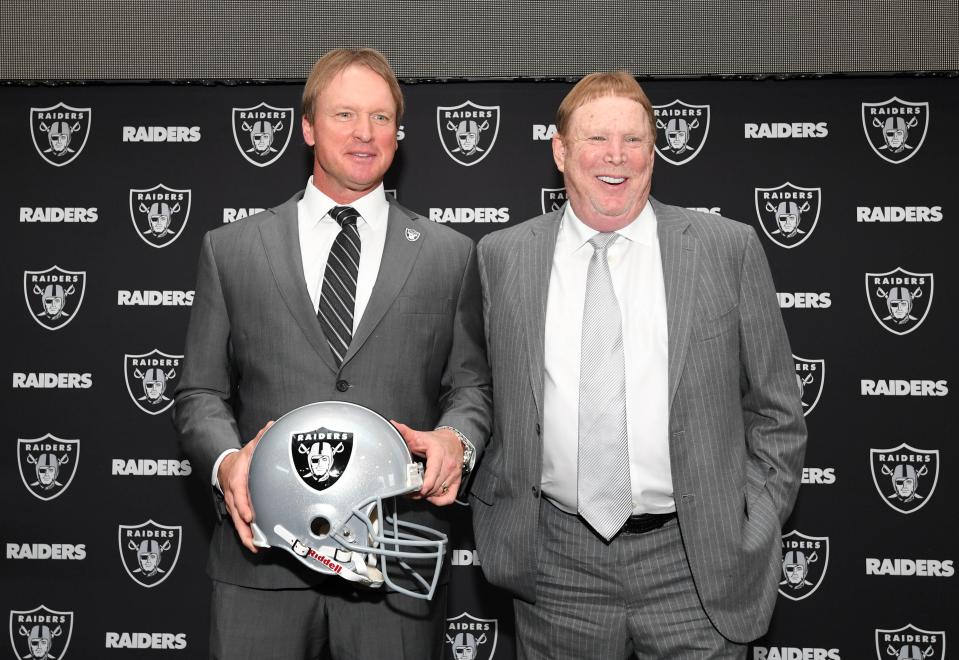 Jon Gruden (L) poses with Raiders owner Mark Davis (R) after being introduced as head coach at a press conference at the Raiders headquarters.