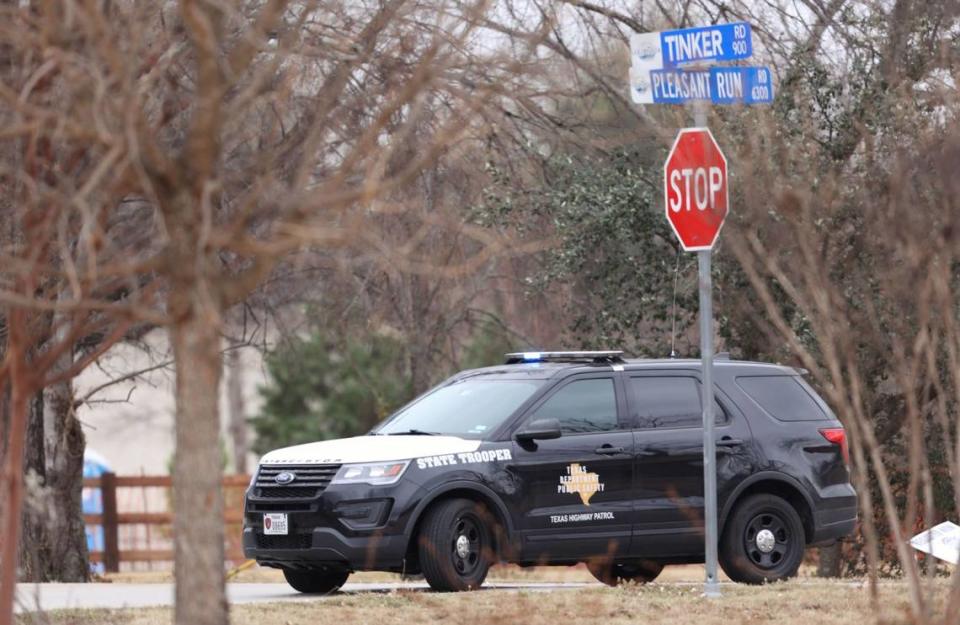 A state trooper blocks a section of Pleasant Run Road. Authorities northeast of Fort Worth are negotiating with a man who has apparently taken people hostage at a Colleyville, Texas synagogue during services. It is unclear if anyone is injured and how the man may be armed.