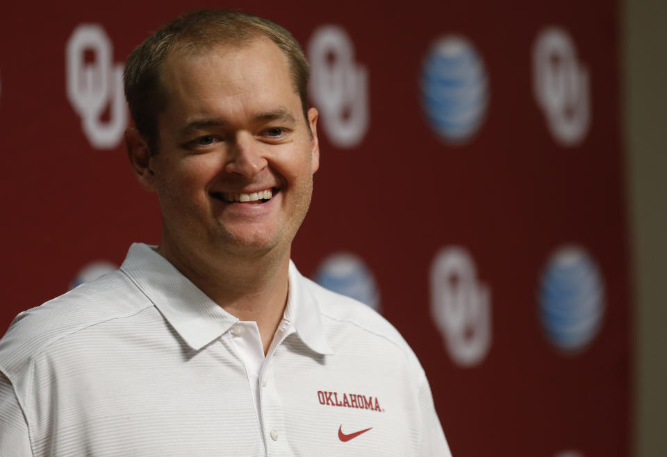 In this Saturday, Aug. 2, 2014 photo, Josh Heupel, Oklahoma co-offensive coordinator and quarterbacks coach, answers a question during media day in Norman, Okla. (AP Photo/Sue Ogrocki)