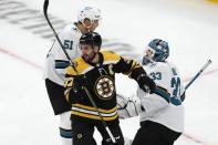 Boston Bruins' Patrice Bergeron (37) turns away from San Jose Sharks' Radim Simek (51) and Adin Hill (33) after the goal by Derek Forbort during the first period of an NHL hockey game, Sunday, Oct. 24, 2021, in Boston. (AP Photo/Michael Dwyer)