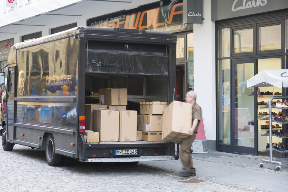 A truck being loaded with packages