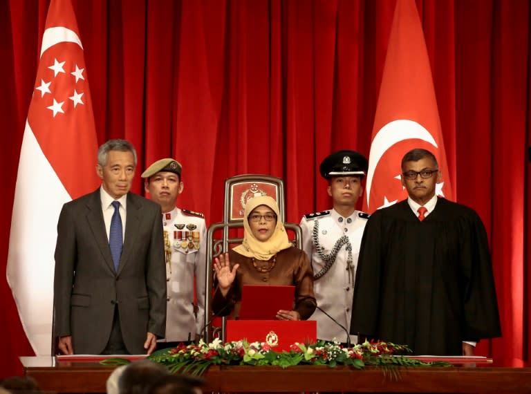 Halimah Yacob (C), a former speaker of parliament from the Malay Muslim minority, won the presidency in a walkover after authorities decided her rivals did not meet strict eligibility criteria