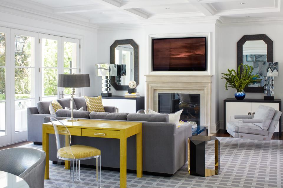 A yellow ostrich leather desk pops against the custom gray mohair sofas (all by Anne Hepfer) in the family room.